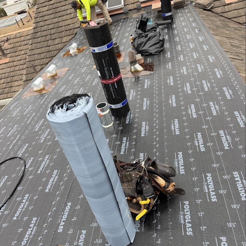Torch down roll roofing installation with tools on flat roof Torch down roll roofing installation with tools on flat roof
