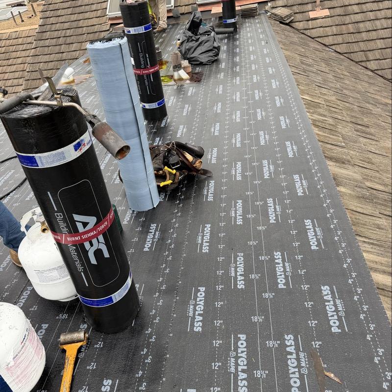 Torch down roofing membrane roll application on flat roof Torch down roofing membrane roll application on flat roof