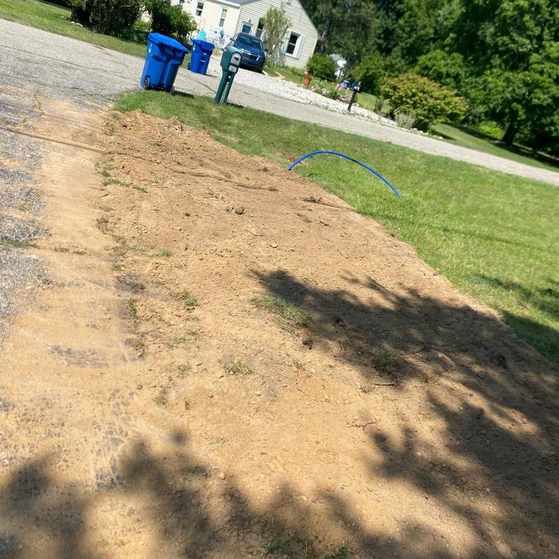 Water service line installation with blue tubing exposed