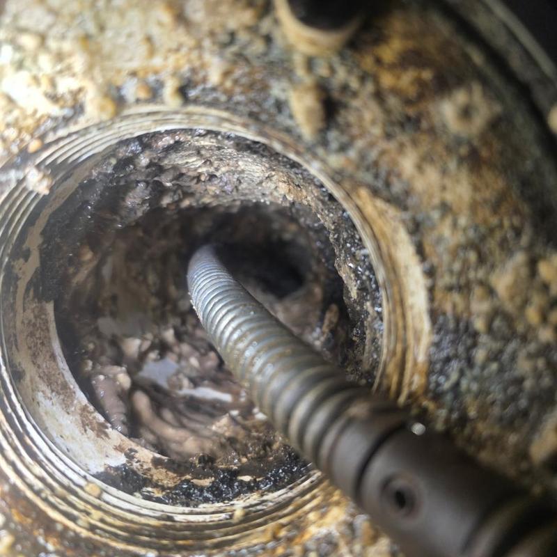 Main sewer line cleaning with drain snake tool
