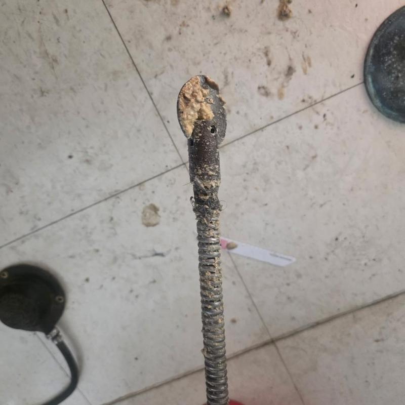 Main sewer drain cleaning snake with debris buildup