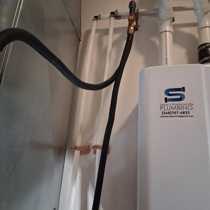 Tankless water heater with repipe and service valves