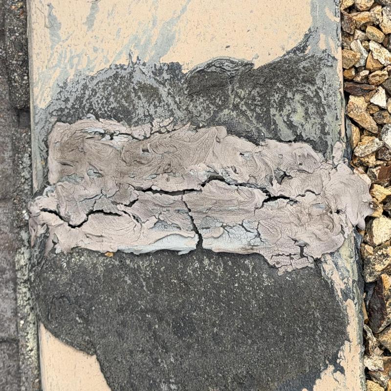 Flat roof flashing with cracked sealant and wear Flat roof flashing with cracked sealant and wear