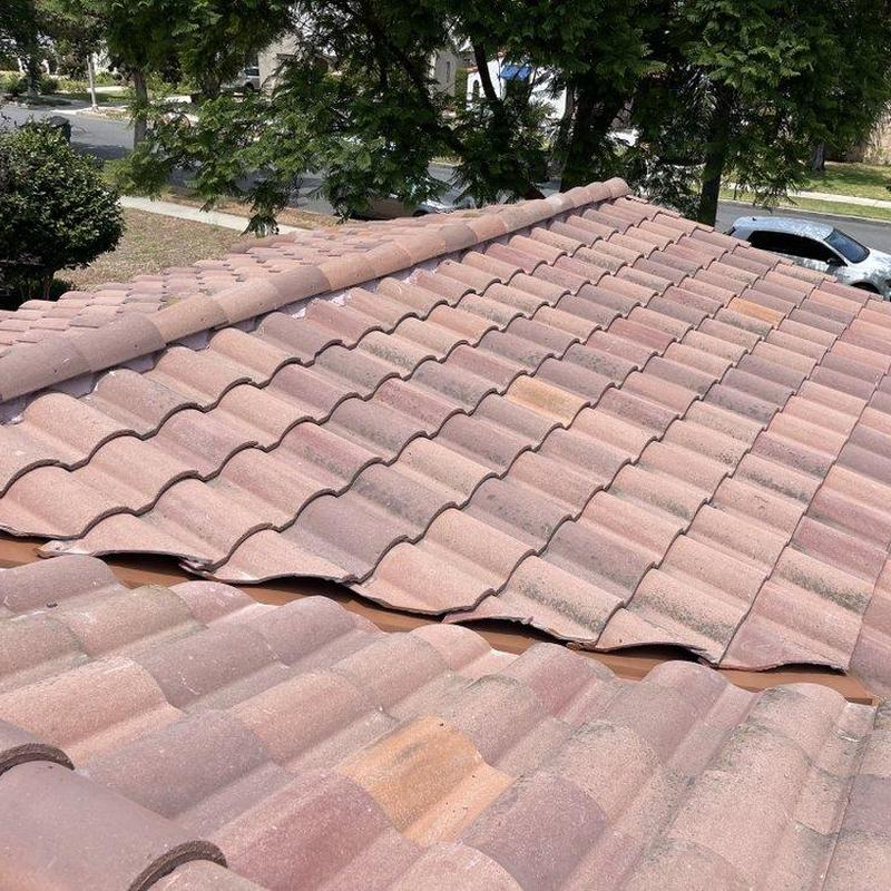 Tile roof with broken and displaced tiles near ridge Tile roof with broken and displaced tiles near ridge