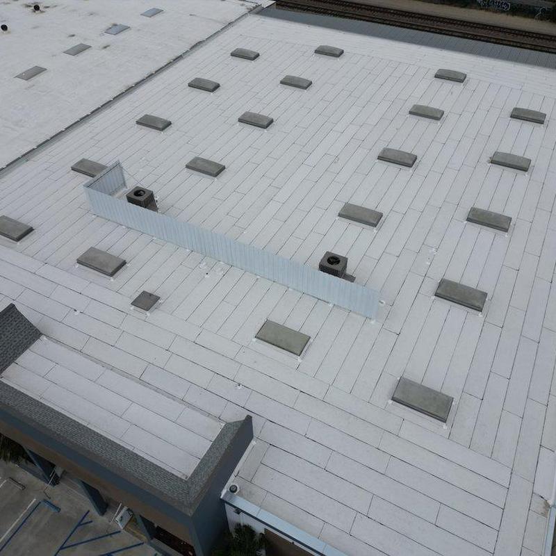 Commercial flat roof with skylight covers and ventilation units Commercial flat roof with skylight covers and ventilation units