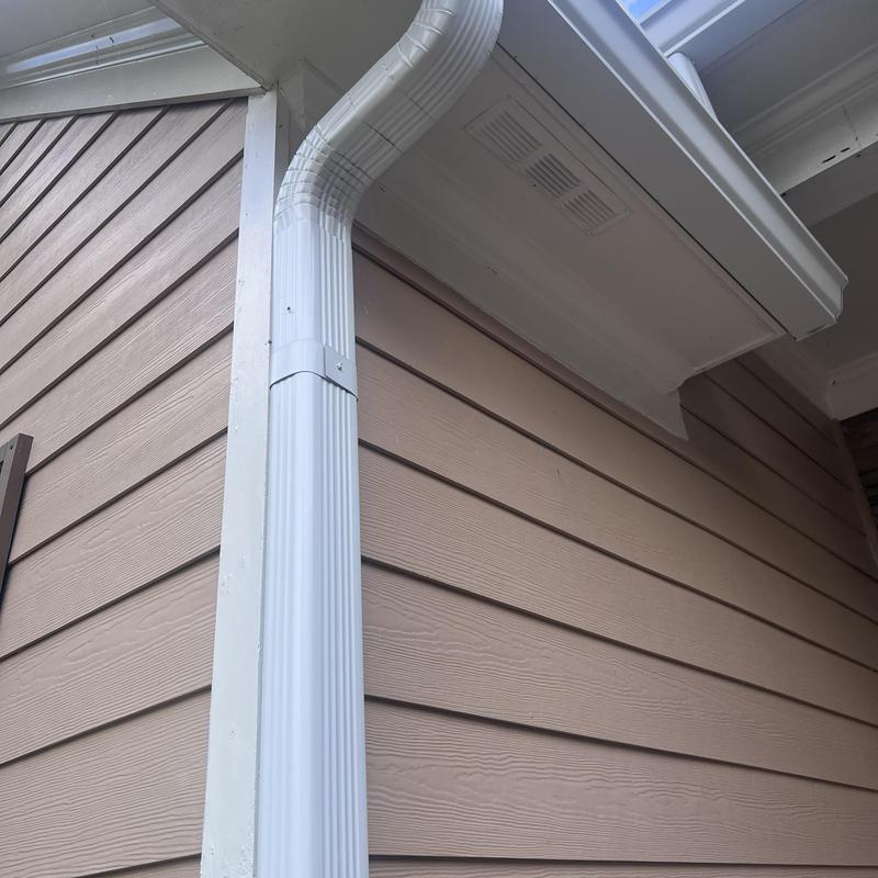 K-style gutter system with downspouts on siding