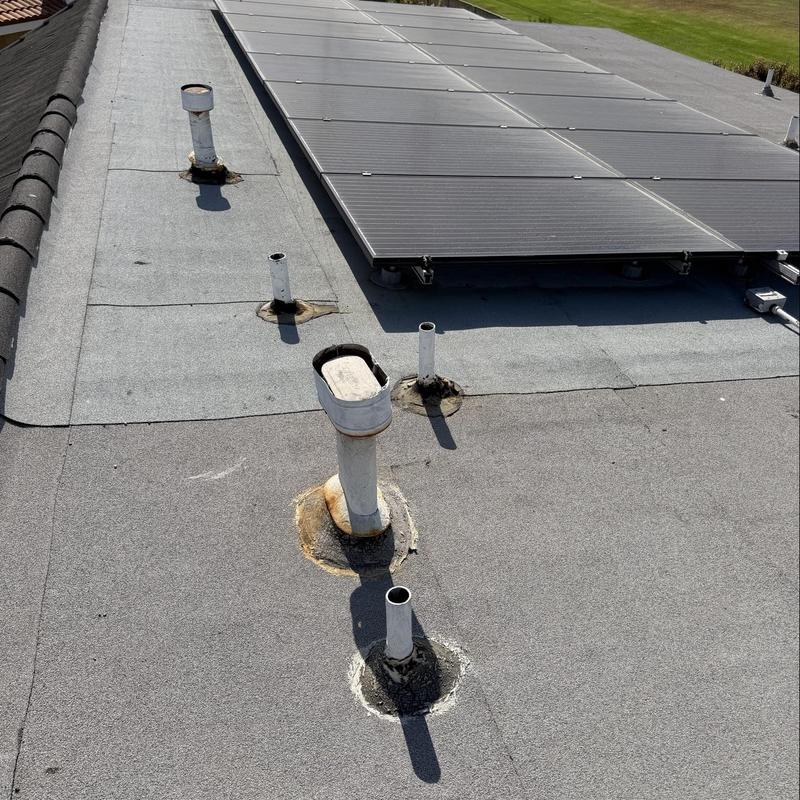 Flat roof with vent pipes and solar panels Flat roof with vent pipes and solar panels