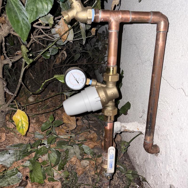 Hose bib and pressure regulator on copper piping