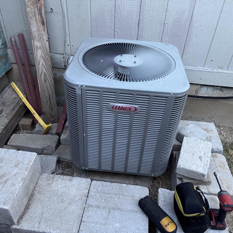 Outdoor Lennox AC condensing unit with tools nearby Outdoor Lennox AC condensing unit with tools nearby
