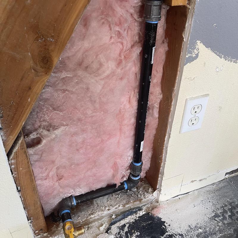 Black steel gas line reroute with new fittings in wall