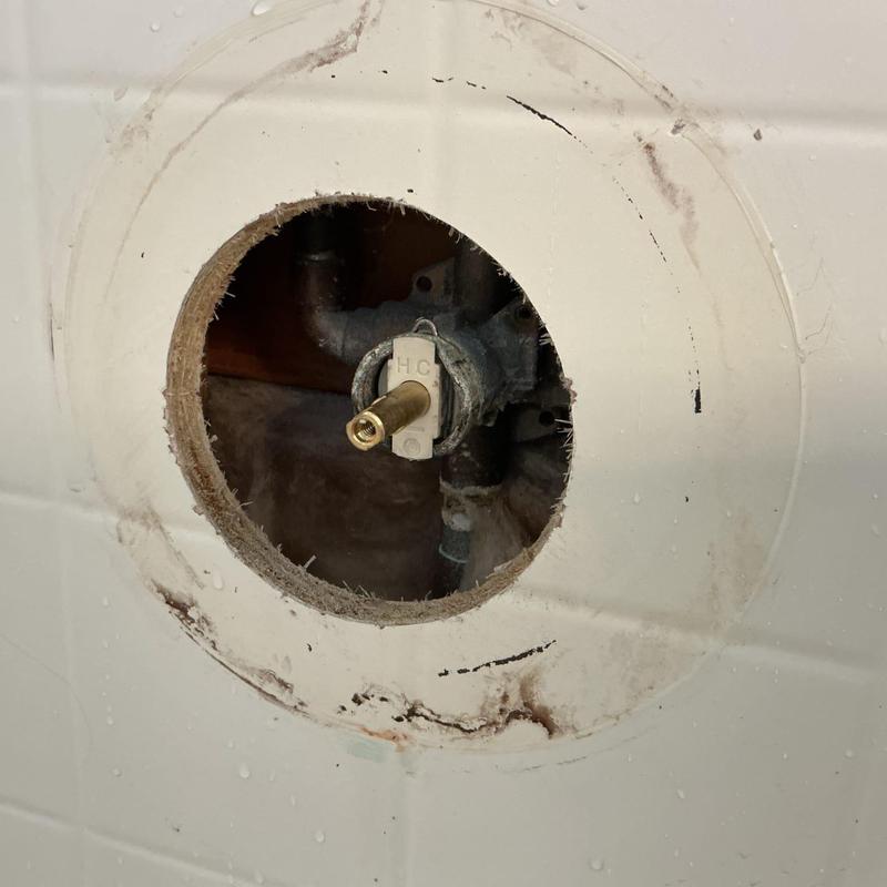 Shower valve cartridge in bathroom wall opening