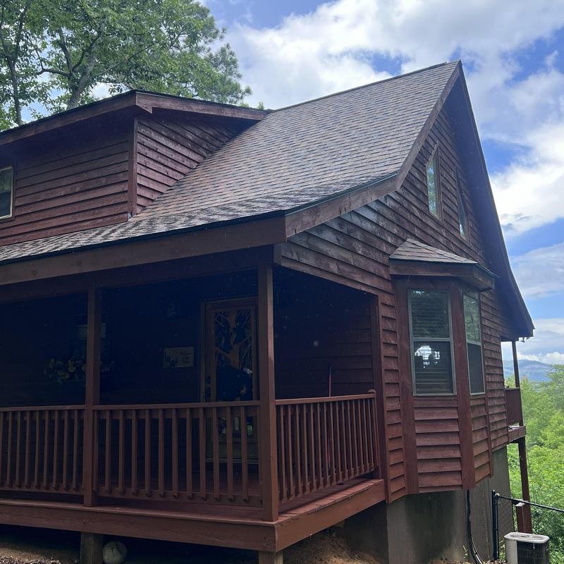 Wood siding and deck with fresh stain and repairs