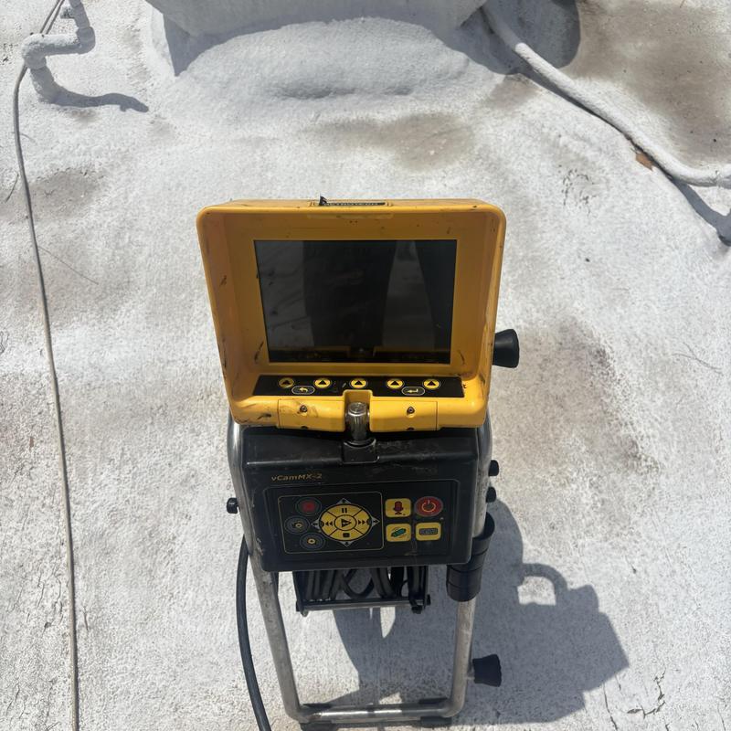 Drain line inspection camera on rooftop surface