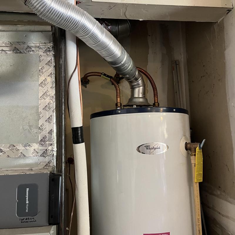 Gas water heater with vent pipe installation in basement Gas water heater with vent pipe installation in basement