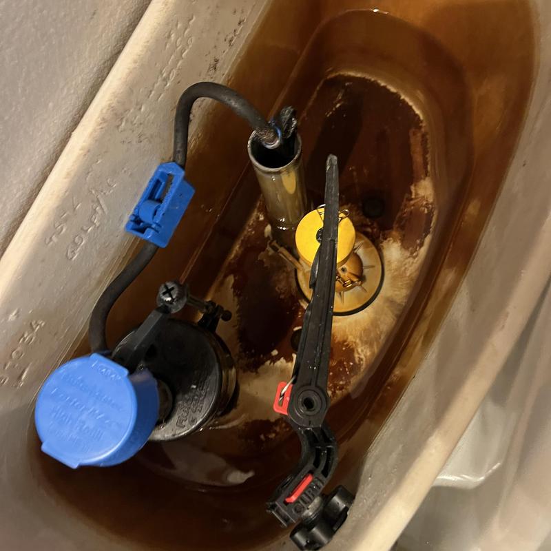 Toilet tank interior showing fill valve and flush lever assembly Toilet tank interior showing fill valve and flush lever assembly
