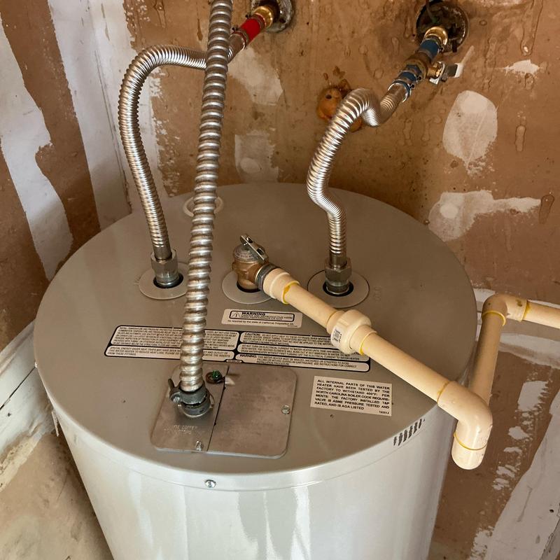 Electric water heater with new pan and drain installation Electric water heater with new pan and drain installation