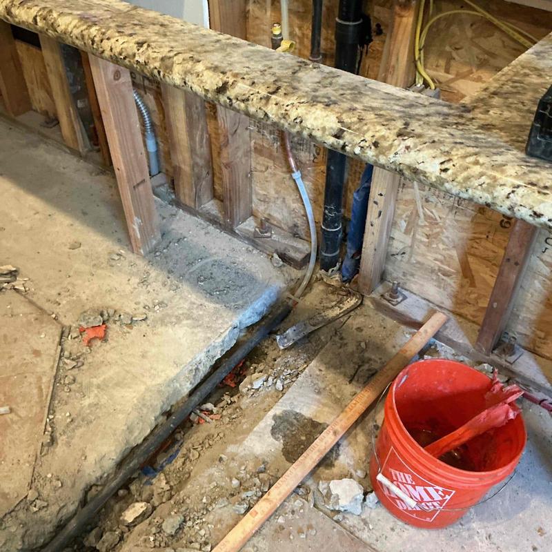 Hot water line reroute under slab with tools
