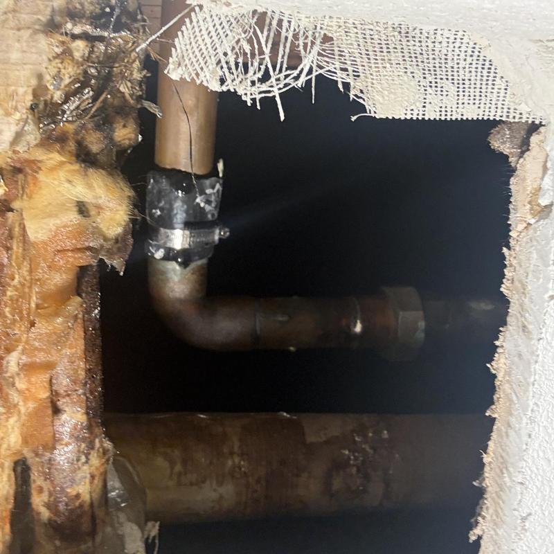 Copper pipe inside cut drywall access hole
