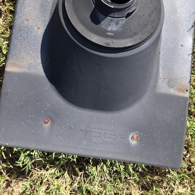 Pipe boot with rusted nails on grass surface