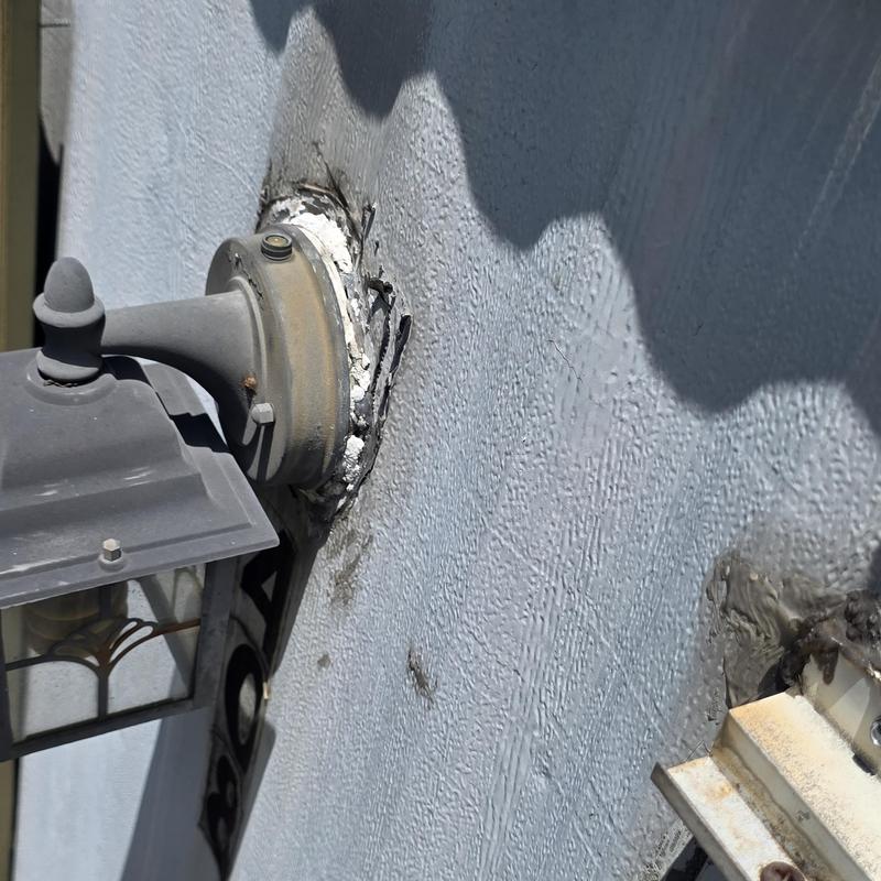 Exterior light fixture with deteriorated wall sealant