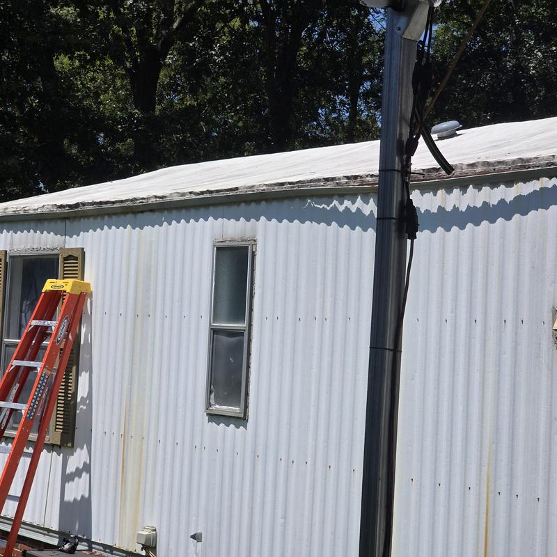 Mobile home door leak with gutters and window caulking