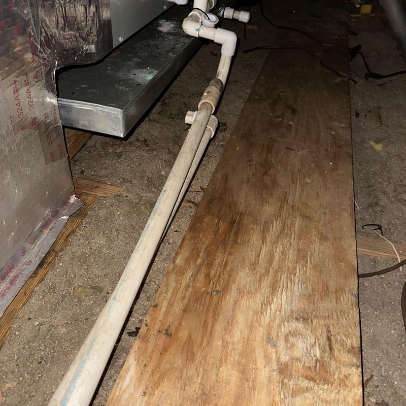 Drain line piping installation under HVAC system