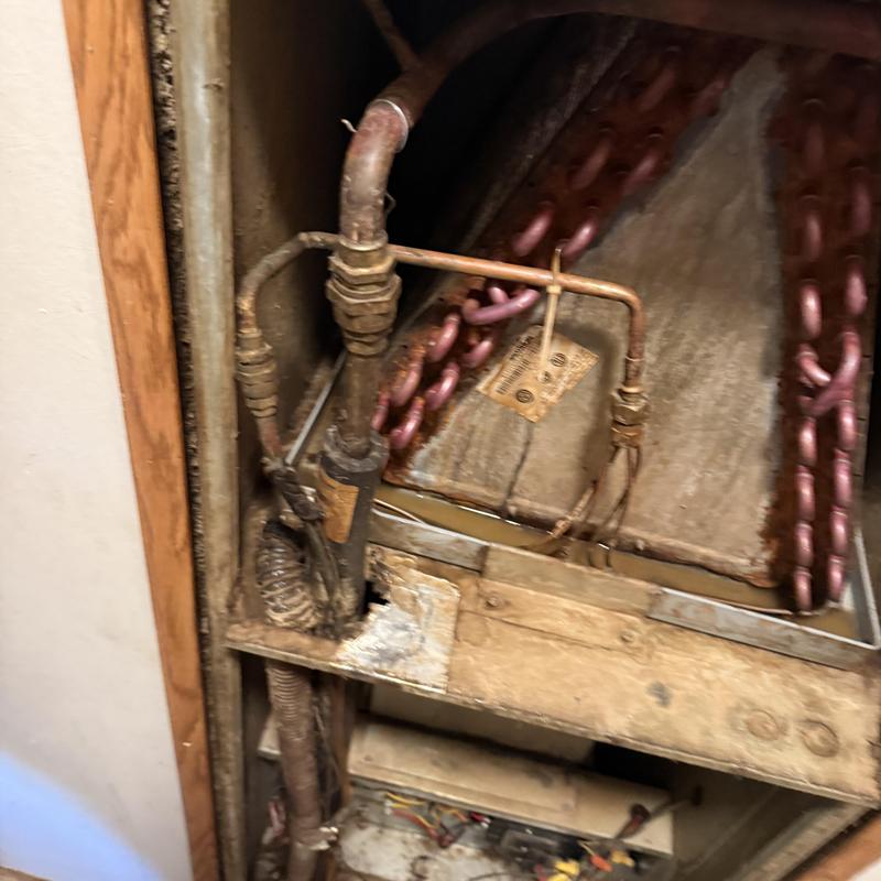 Air handler coil with rust damage and corroded pipes