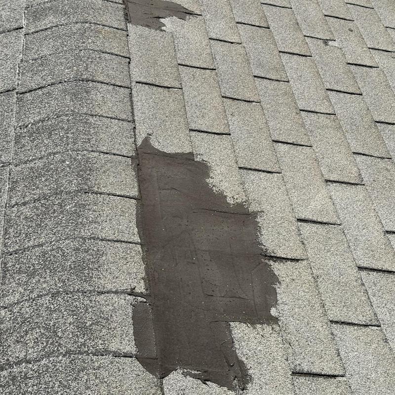 Shingle roof with patched damaged area Shingle roof with patched damaged area