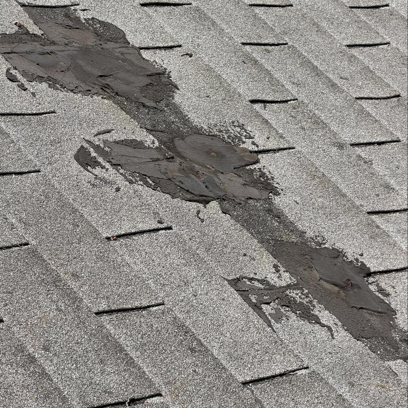 Shingle roof with patching sealant and damage Shingle roof with patching sealant and damage