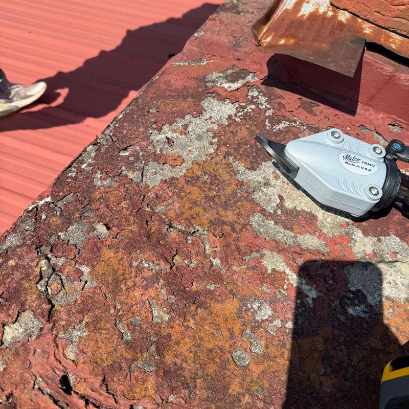 Metal roof valley with extensive corrosion and damage Metal roof valley with extensive corrosion and damage
