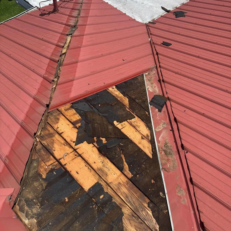 Metal roof valley with damaged decking and underlayment Metal roof valley with damaged decking and underlayment