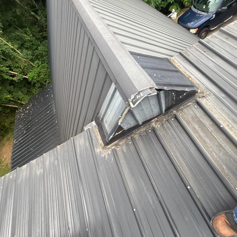 Roof vent with rust and damaged flashing on metal roof Roof vent with rust and damaged flashing on metal roof
