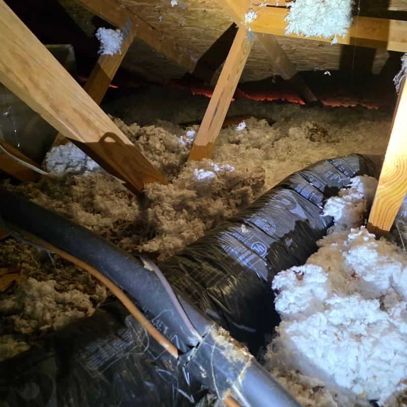 Attic insulation and ductwork under roof rafters Attic insulation and ductwork under roof rafters