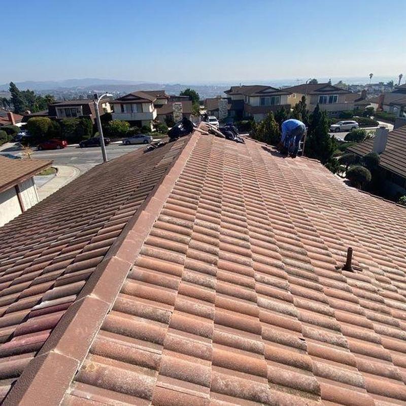 Tile roof inspection with technician on slope Tile roof inspection with technician on slope