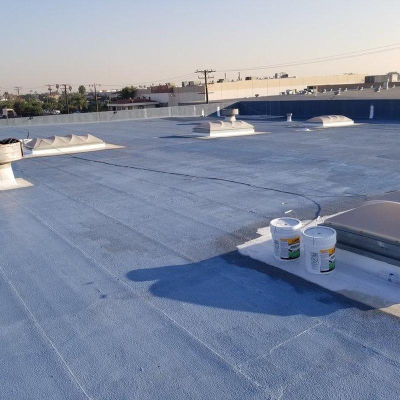 Commercial flat roof with coating and vents Commercial flat roof with coating and vents