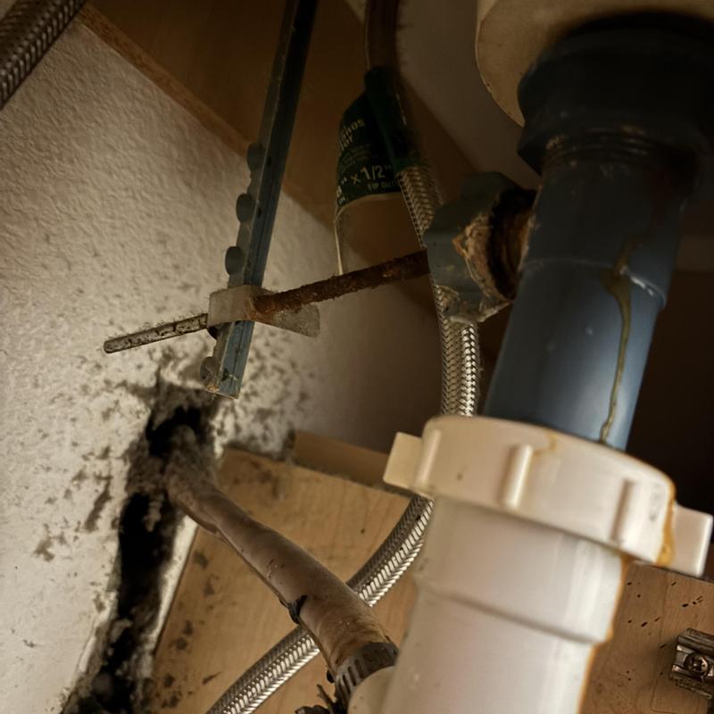 P-trap drain line with rusted support bracket