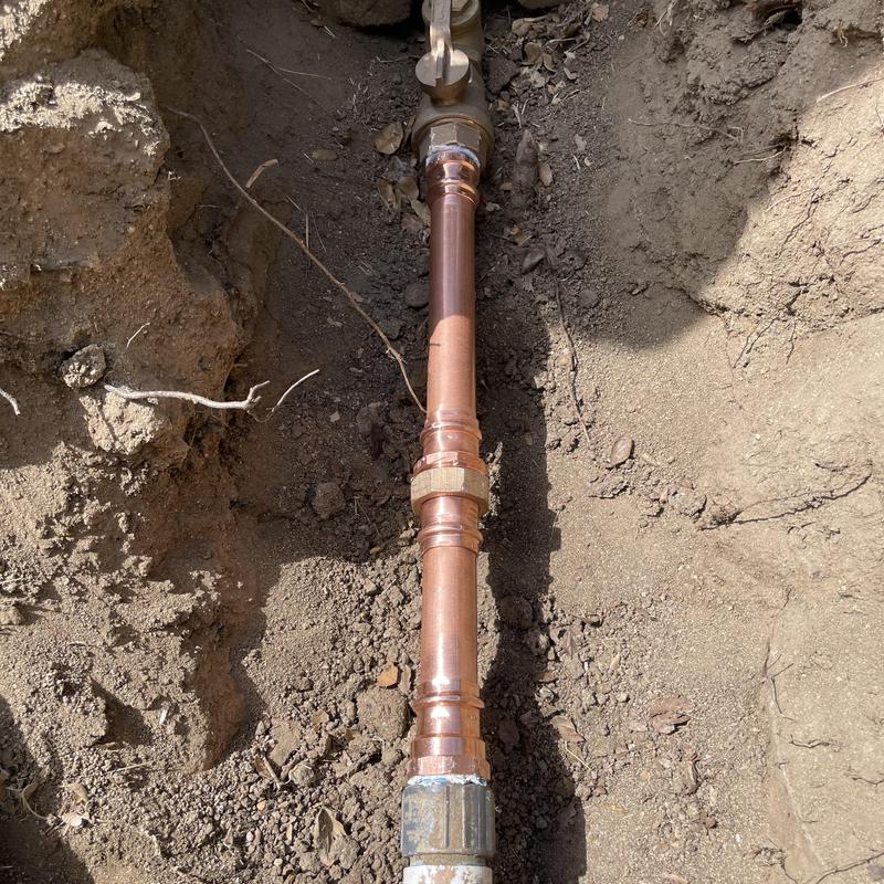 Copper water pipe with press fittings in trench
