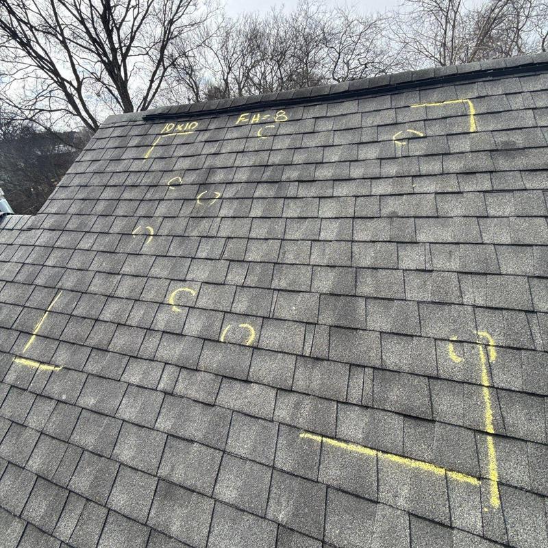 Asphalt shingle roof with hail damage markings