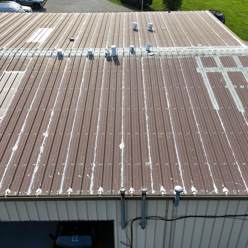 Metal roof with sealed seams and vent pipes