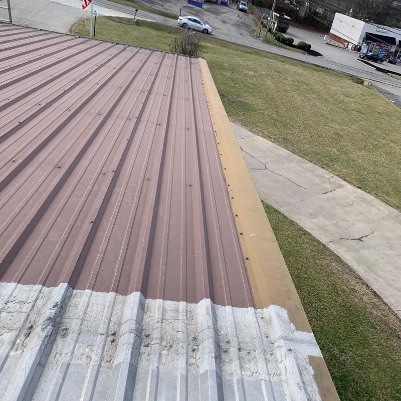 Metal roof panels with hail damage inspection at municipal building