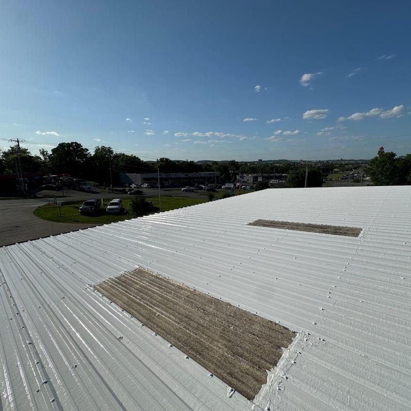 Metal roof panels with damaged skylights and sealant