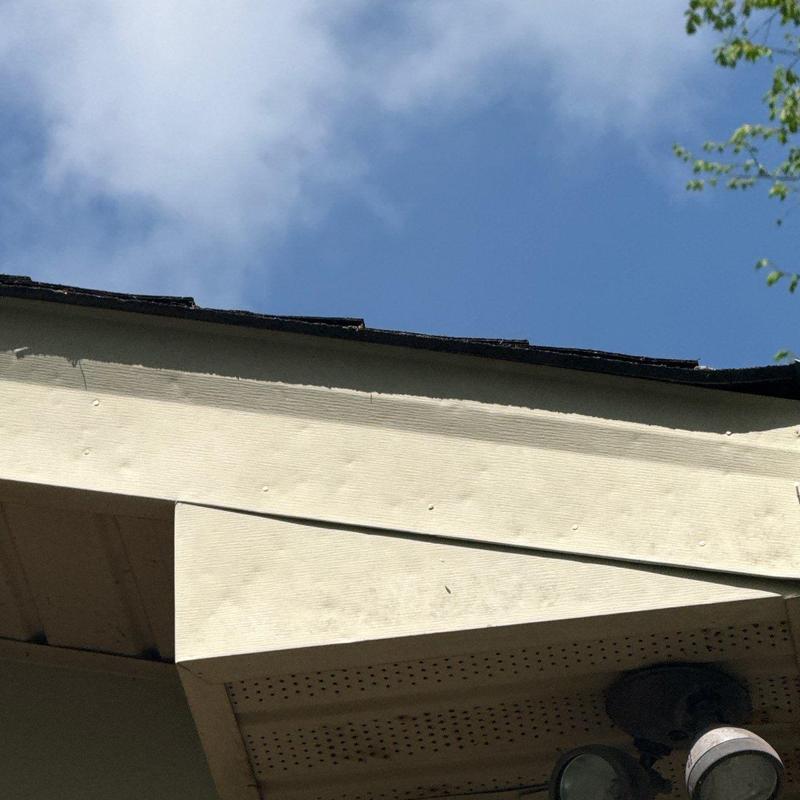 Roof fascia and shingle edge with hail damage