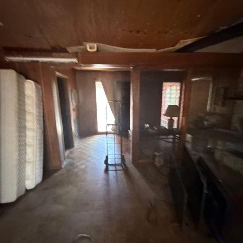 Interior room wood paneling and flooring damaged