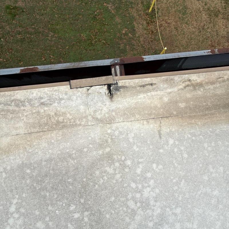 Roof flashing with hail damage and cracks