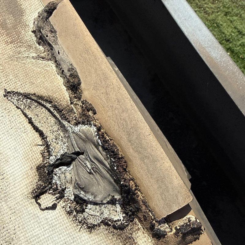 Roof flashing with hail damage close-up detail