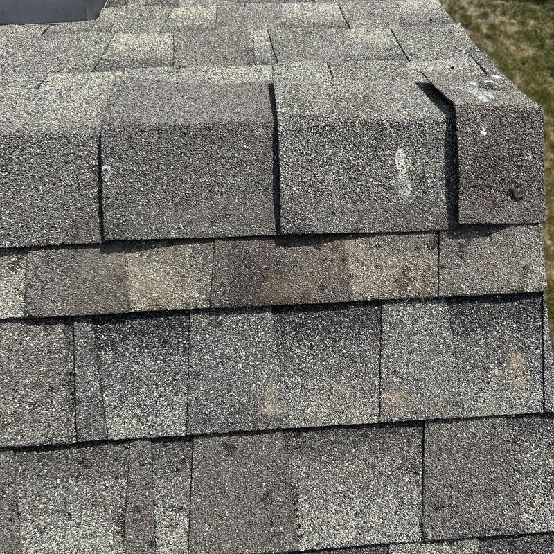 Asphalt shingle roof with ridge cap repair work Asphalt shingle roof with ridge cap repair work