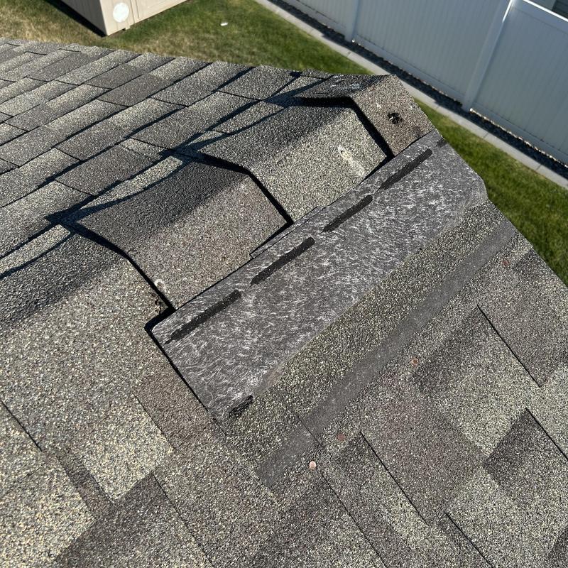 Roof shingles and ridge vent repair on residential roof Roof shingles and ridge vent repair on residential roof