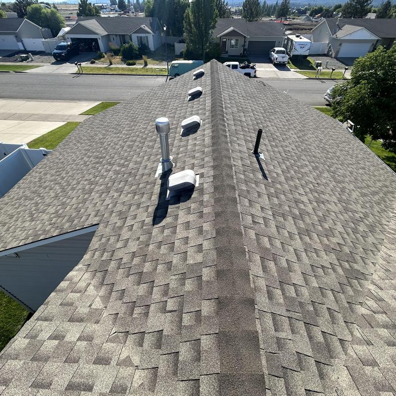 Asphalt shingle roof with vents and ridge cap installation Asphalt shingle roof with vents and ridge cap installation