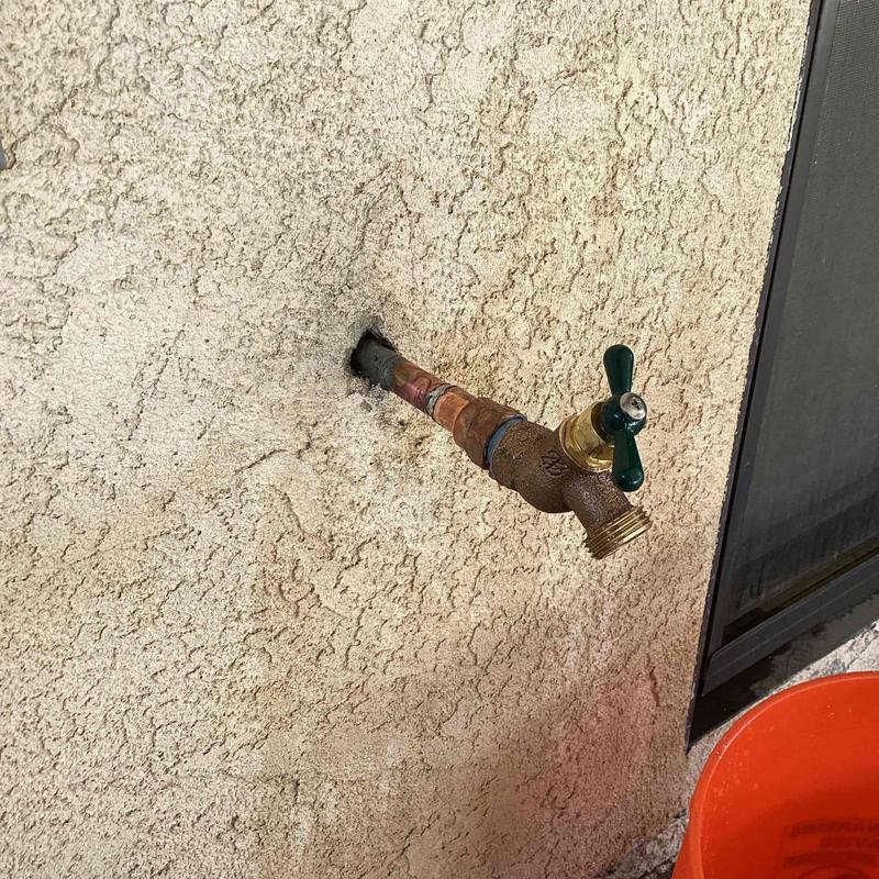 Threaded hose bib on exterior stucco wall