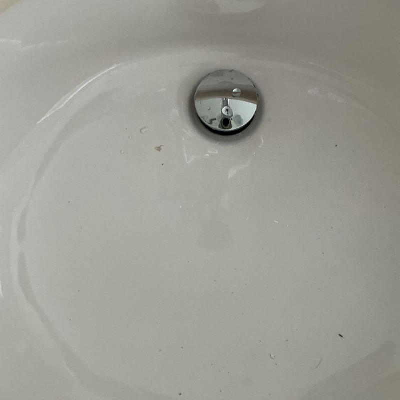 Pop-up drain installed in white sink basin